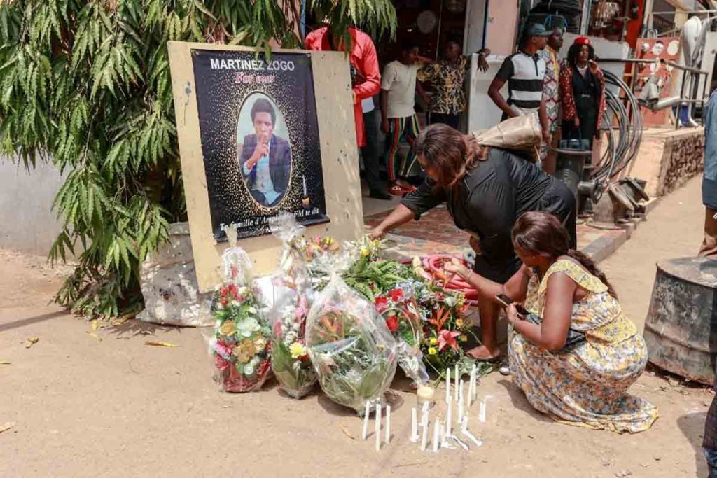 Mourners place a candles and flowers in the courtyard of Radio Amplitude FM, during a tribute ceremony for journalist Martinez Zogo, in the Elig Essono district of Yaounde on January 23, 2023. - A popular Cameroon radio journalist who had been missing following what a media rights group called an abduction has been found dead, his employer and police said on January 22, 2023.
Martinez Zogo was managing director of Yaounde-based private radio station Amplitude FM and the star host of a popular daily programme, Embouteillage (Gridlock).
On the air, the 51-year-old regularly tackled cases of corruption, not hesitating to question important personalities by name. (Photo by Daniel Beloumou Olomo / AFP)