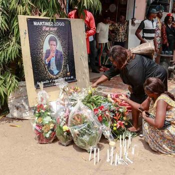 Mourners place a candles and flowers in the courtyard of Radio Amplitude FM, during a tribute ceremony for journalist Martinez Zogo, in the Elig Essono district of Yaounde on January 23, 2023. - A popular Cameroon radio journalist who had been missing following what a media rights group called an abduction has been found dead, his employer and police said on January 22, 2023.
Martinez Zogo was managing director of Yaounde-based private radio station Amplitude FM and the star host of a popular daily programme, Embouteillage (Gridlock).
On the air, the 51-year-old regularly tackled cases of corruption, not hesitating to question important personalities by name. (Photo by Daniel Beloumou Olomo / AFP)